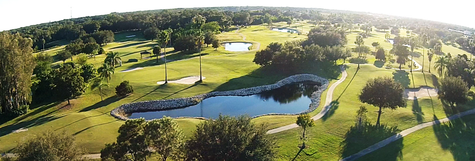 Panoramic view of a lush green golf course at River Run Golf Links. Smooth