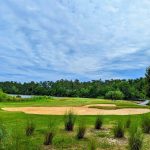 Panoramic view of a lush green golf course at Rivers Edge Golf Club and Plantation. Smooth