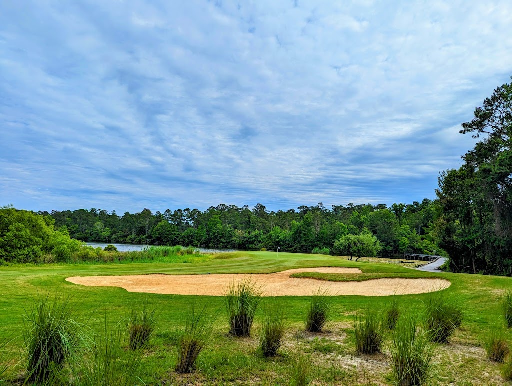 Panoramic view of a lush green golf course at Rivers Edge Golf Club and Plantation. Smooth