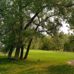 Panoramic view of a lush green golf course at Rivers Edge Golf Course. Smooth