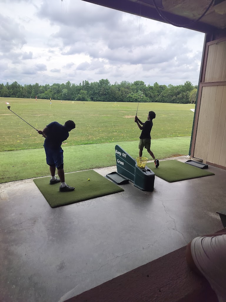 Panoramic view of a lush green golf course at Riverside Golf Academy. Smooth