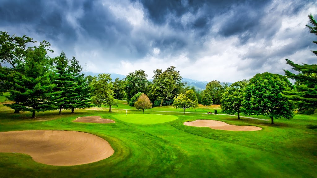 Panoramic view of a lush green golf course at Riverside Golf Course. Smooth
