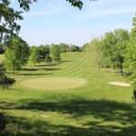 green grass with the flag in the hole.