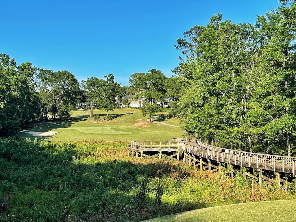 Panoramic view of a lush green golf course at Rock Creek Golf Club. Smooth