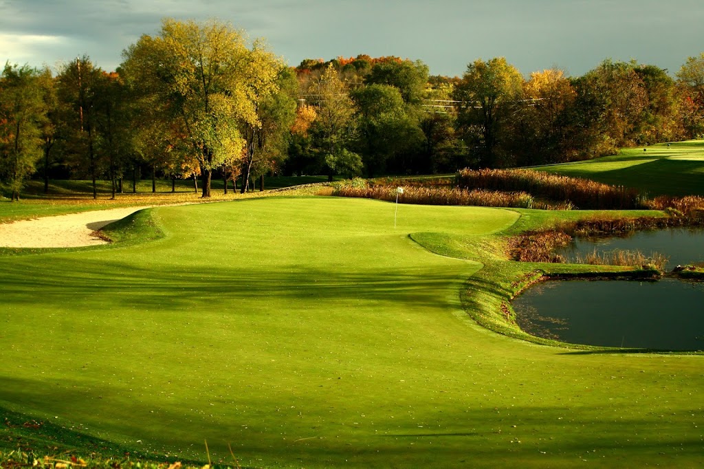 Panoramic view of a lush green golf course at Rock Harbor Golf Course. Smooth