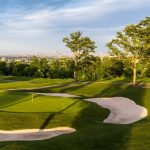 Panoramic view of a lush green golf course at Rock Spring Golf Club. Smooth
