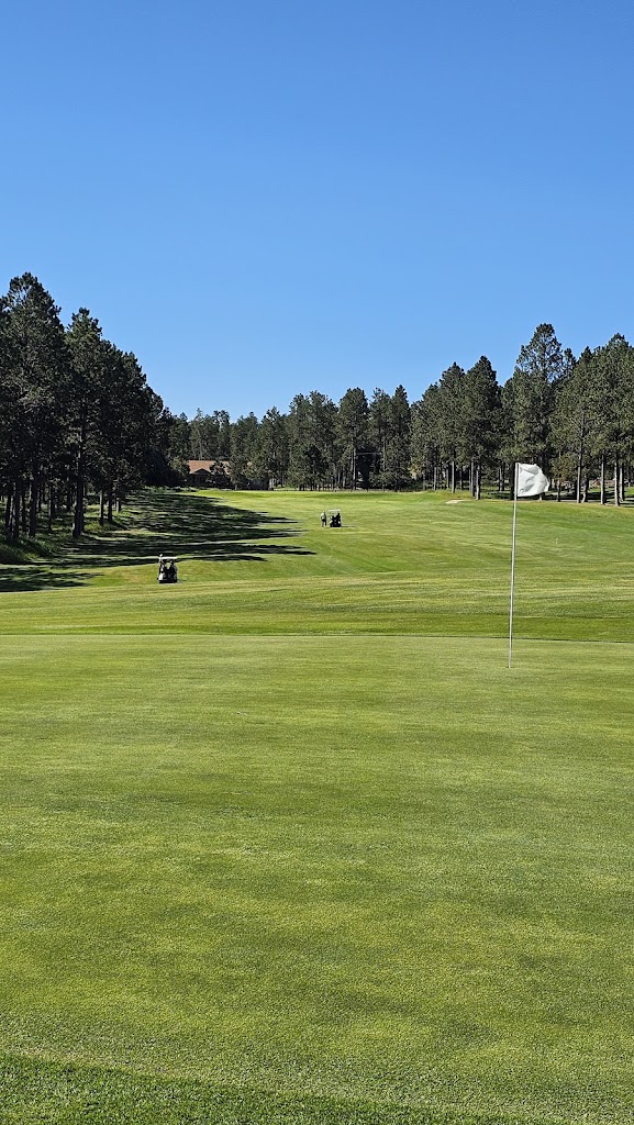 Panoramic view of a lush green golf course at Rocky Knolls Golf Course. Smooth