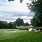 Panoramic view of a lush green golf course at Rocky River Golf Club At Concord. Smooth