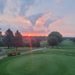 Panoramic view of a lush green golf course at Rocky Run Golf Course. Smooth
