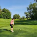 green grass with the flag in the hole.