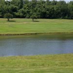 Panoramic view of a lush green golf course at Rolling Green Golf Course. Smooth