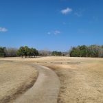Panoramic view of a lush green golf course at Rolling Hills Country Club. Smooth