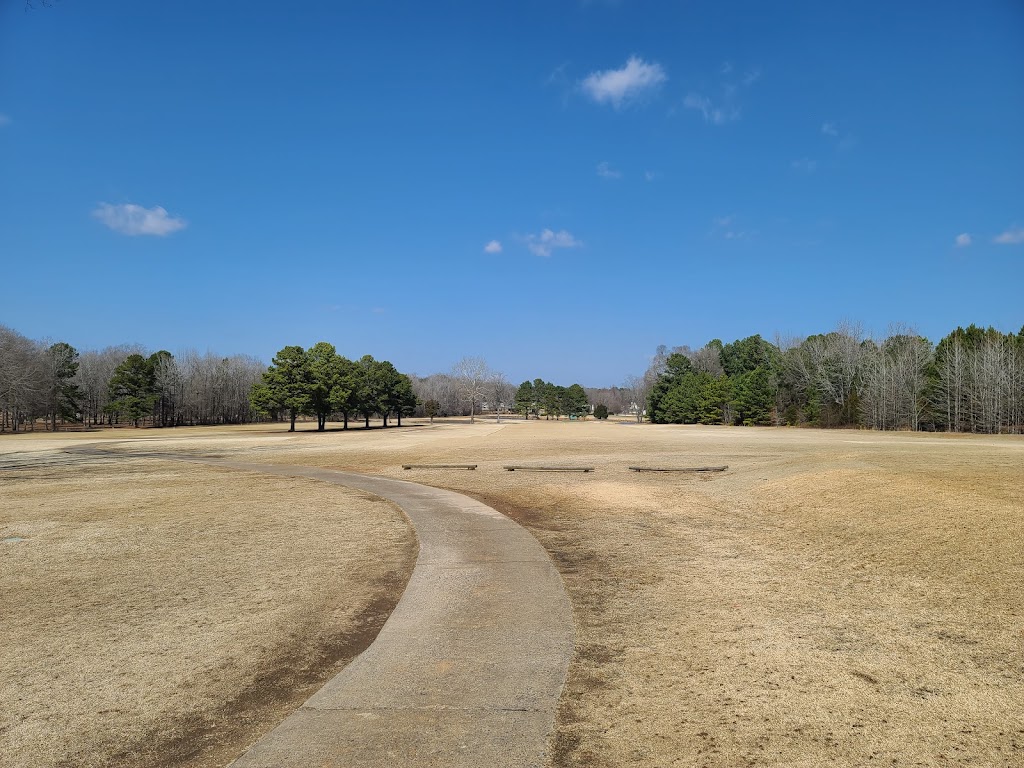 Panoramic view of a lush green golf course at Rolling Hills Country Club. Smooth