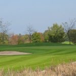 Panoramic view of a lush green golf course at Rolling Meadows Golf Course. Smooth