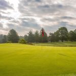 Panoramic view of a lush green golf course at Rolling Meadows Golf Course. Smooth