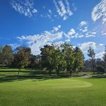 Panoramic view of a lush green golf course at Roosevelt Golf Course. Smooth