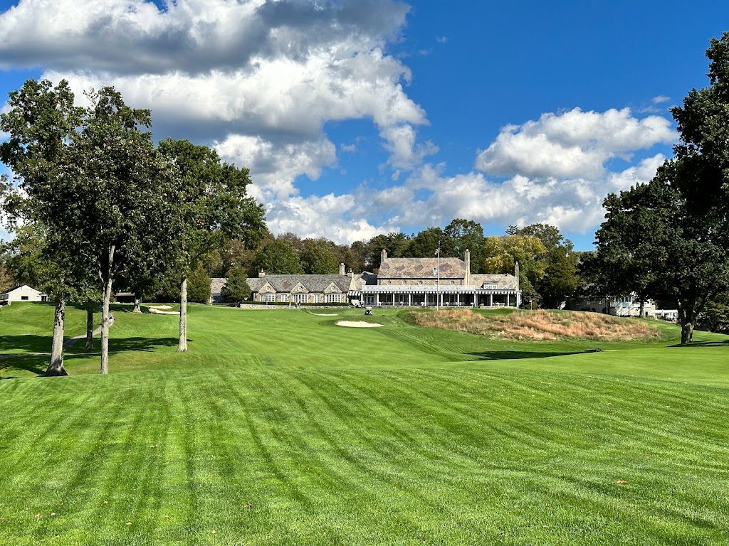 Panoramic view of a lush green golf course at Round Hill Club. Smooth