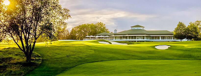 Panoramic view of a lush green golf course at Royal Golf Club. Smooth