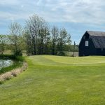 Panoramic view of a lush green golf course at Royal Hylands Golf Club. Smooth