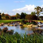Panoramic view of a lush green golf course at Royal Oaks Country Club. Smooth
