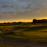 Panoramic view of a lush green golf course at Royal St. Patrick's Golf Links. Smooth