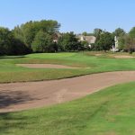 green grass with the flag in the hole.