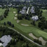 Panoramic view of a lush green golf course at Ruffled Feathers Golf Club. Smooth