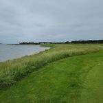 Panoramic view of a lush green golf course at Rum Pointe Seaside Golf Links. Smooth