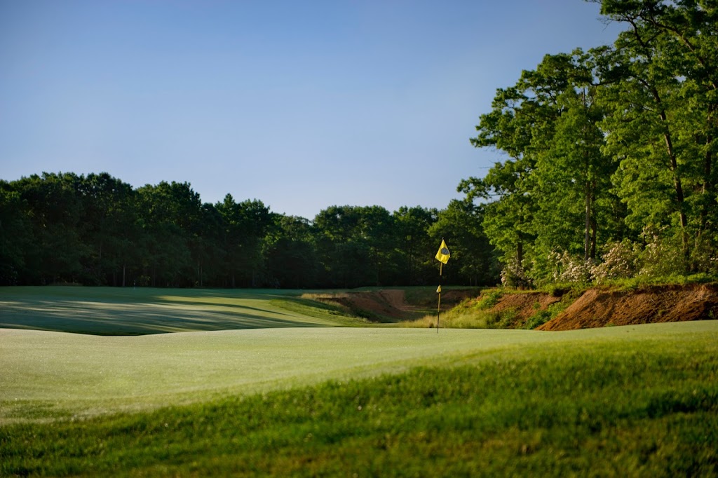 Panoramic view of a lush green golf course at Running Deer Golf Club. Smooth