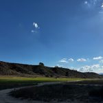 Panoramic view of a lush green golf course at Rustic Canyon Golf Course. Smooth