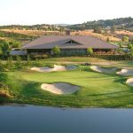 Panoramic view of a lush green golf course at Saddle Creek Golf Resort. Smooth