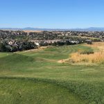 Panoramic view of a lush green golf course at Saddle Rock Golf Course. Smooth