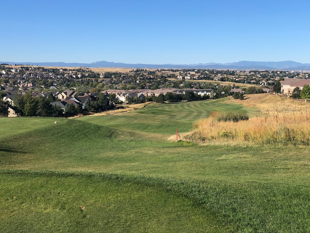 Panoramic view of a lush green golf course at Saddle Rock Golf Course. Smooth