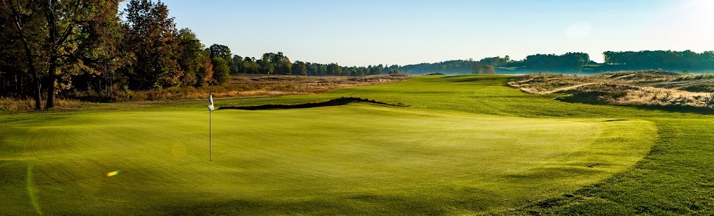 Panoramic view of a lush green golf course at Sage Run Golf Course. Smooth