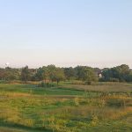 Panoramic view of a lush green golf course at Salina Municipal Golf Course. Smooth