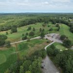 Panoramic view of a lush green golf course at Salmon Falls Country Club. Smooth