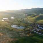 Panoramic view of a lush green golf course at San Juan Oaks Golf Club. Smooth