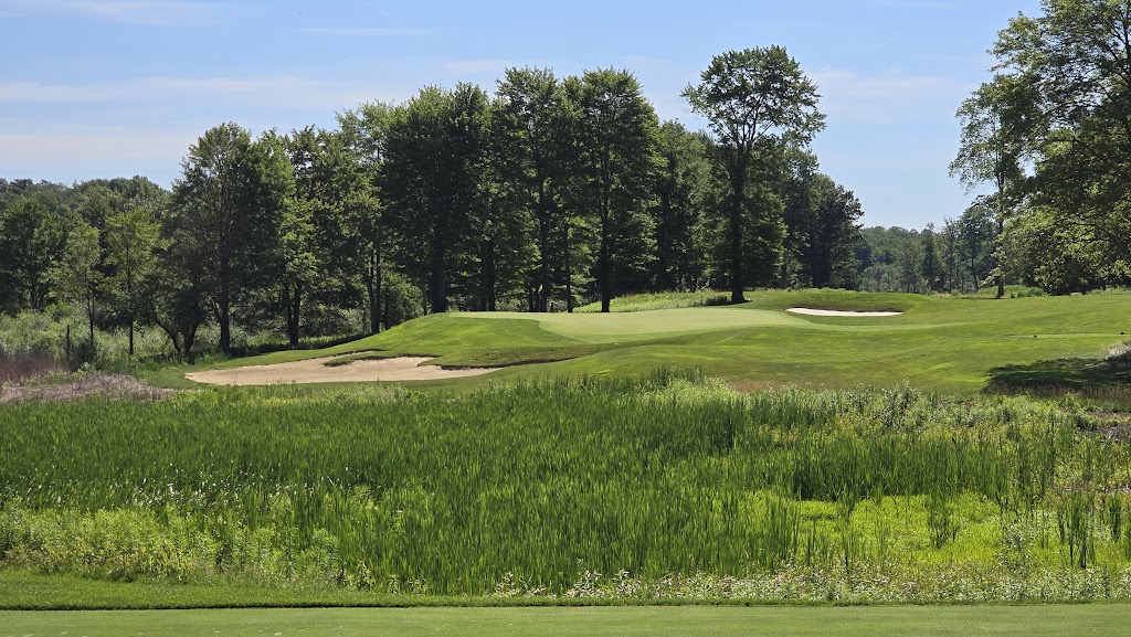 Panoramic view of a lush green golf course at Sand Ridge Golf Club. Smooth