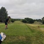 green grass with the flag in the hole.