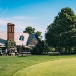 Panoramic view of a lush green golf course at Sandy Hollow Golf Course. Smooth