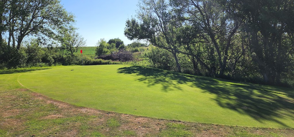 Panoramic view of a lush green golf course at Sandy Meadows Golf Course. Smooth