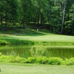 Panoramic view of a lush green golf course at Sanford Country Club. Smooth