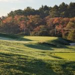 Panoramic view of a lush green golf course at Sassamon Trace Golf Course. Smooth