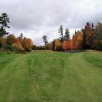 Panoramic view of a lush green golf course at Sawmill Woods Golf Course. Smooth