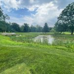 Panoramic view of a lush green golf course at Saxon Woods Golf Course. Smooth
