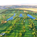 Panoramic view of a lush green golf course at Schneiter's Bluff Golf Course. Smooth