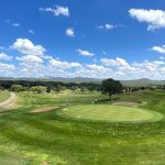 Panoramic view of a lush green golf course at Scott Park Golf Links. Smooth