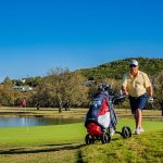 Panoramic view of a lush green golf course at Scott Schreiner Municipal Golf Course. Smooth