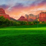 Panoramic view of a lush green golf course at Sedona Golf Resort. Smooth