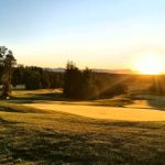 Panoramic view of a lush green golf course at Settlers Bay Golf Course. Smooth